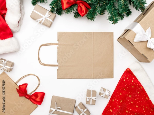 Fototapeta gifts package box white background christmas tree red hat new year delivery top view