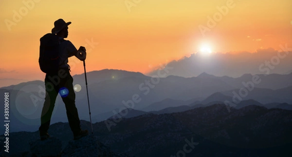 Fototapeta magnificent sunset, mountain climber watching, diving in peace