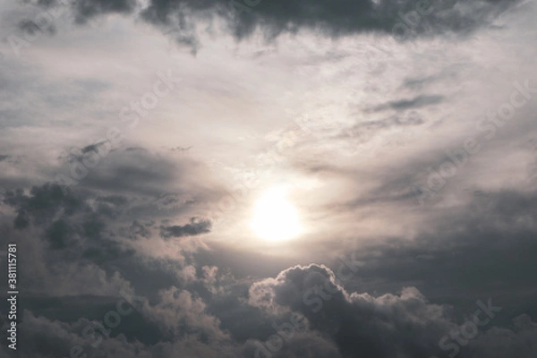 Obraz Grey high layered grey epic clouds with sun and sunlight on sky. Heaven cloudscape air view