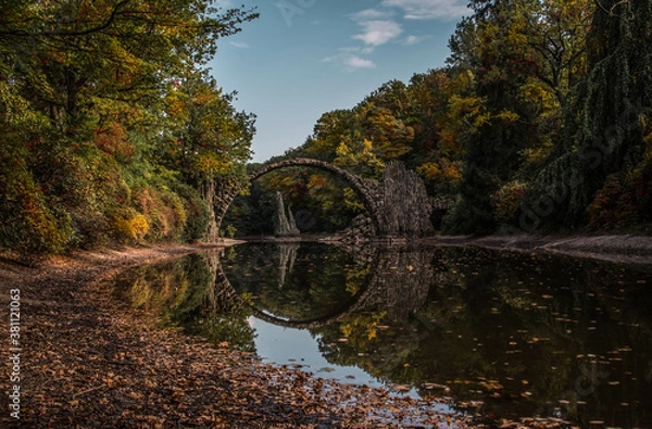Fototapeta Ancient stone bridge in water reflection