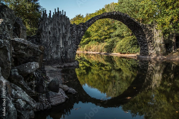 Fototapeta Ancient stone bridge in water reflection