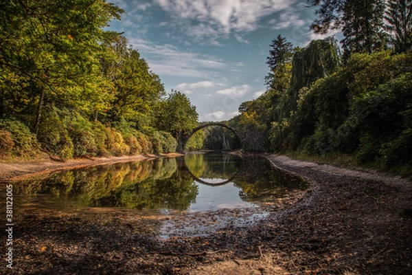 Fototapeta Ancient stone bridge in water reflection