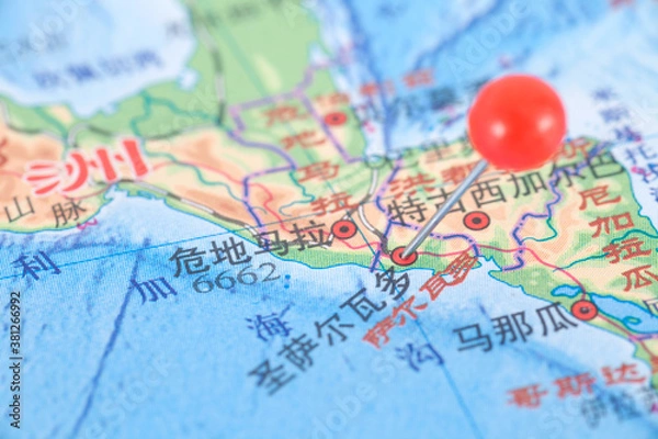 Fototapeta Pushpins mark the location of San Salvador, the capital of El Salvador, on the map