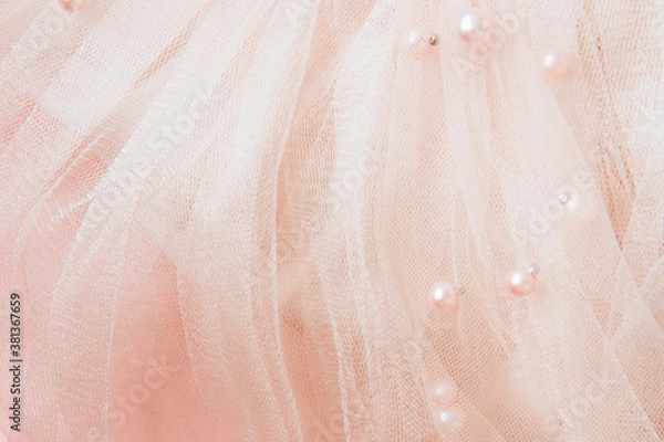 Fototapeta Beautiful nude pink tulle with shiny beads background. Draped background of pink powdery fabric, texture. Copy space. Close up