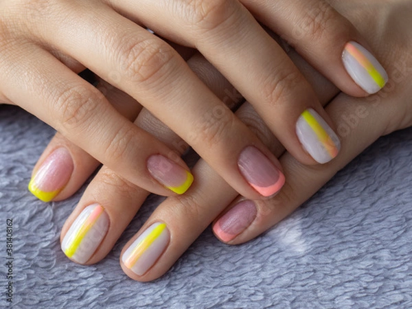 Fototapeta Nice women's manicure, a combination of three colors, pink, yellow and white