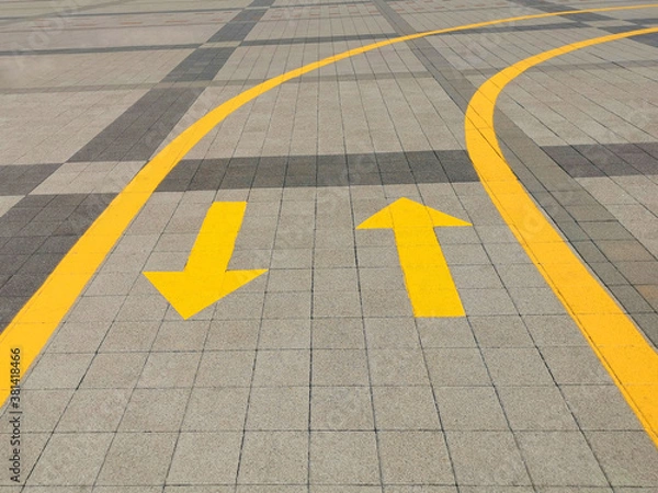 Fototapeta Up and down arrows on the road. Yellow arrows on the road, directing traffic flow