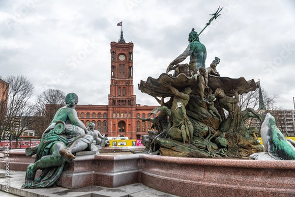 Fototapeta Neptune Fountain with the Red City Hall of Berlin in the background on a winter day