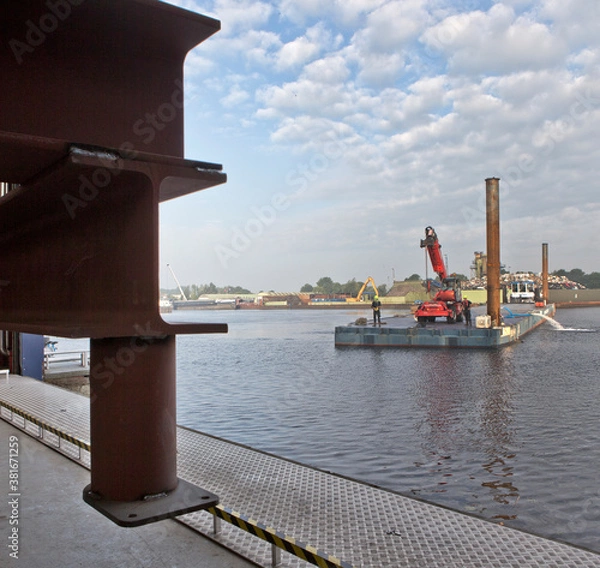 Fototapeta Pontoon with tugboat in harbour. Ship building industry. Netherlands. Shipyard.