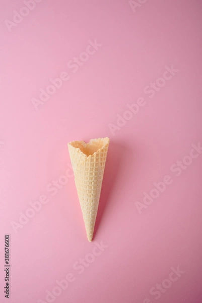 Obraz Empty waffle cone on a pink background close-up