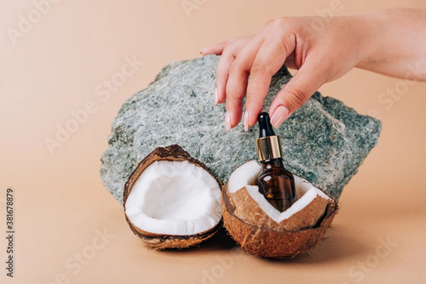 Obraz Coconut and a tube of cosmetics on a stone background