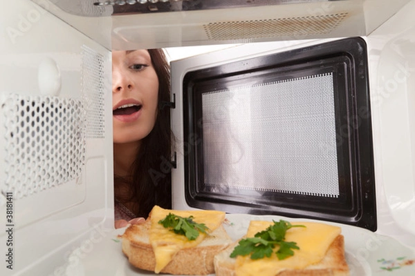 Obraz Girl open a microwave