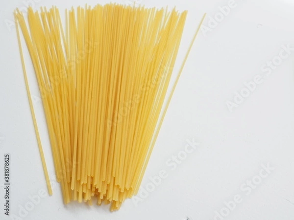 Obraz Raw dry spaghetti italian pasta spaghetti line, Yellow long spaghetti on white wooden background, Food background concept.