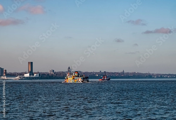 Fototapeta Liverpool, UK. Beautiful colorful long exposure shot of river Mersey from Albert Dock with smooth reflections of night lights from the other side of a shore and a boat. 
