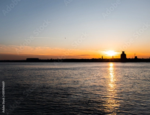 Fototapeta Liverpool, UK. Beautiful colorful long exposure shot of river Mersey from Albert Dock with smooth reflections of night lights from the other side of a shore. 