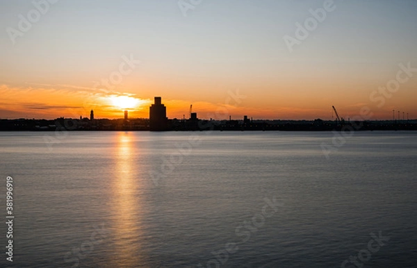 Fototapeta Liverpool, UK. Beautiful colorful long exposure shot of river Mersey from Albert Dock with smooth reflections of night lights from the other side of a shore. 