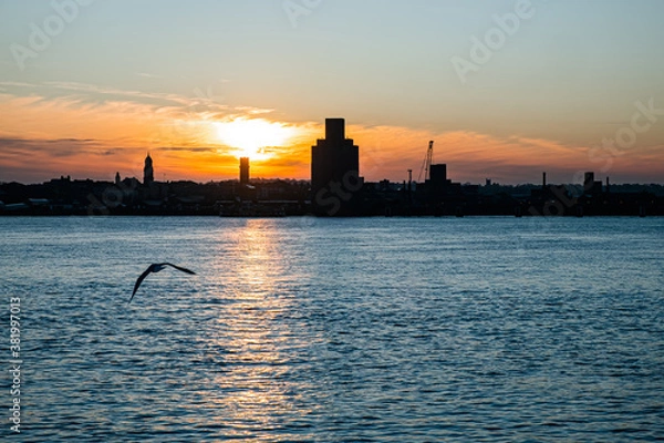 Fototapeta Liverpool, UK. Beautiful colorful long exposure shot of river Mersey from Albert Dock with smooth reflections of night lights from the other side of a shore. 