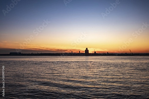Fototapeta Liverpool, UK. Beautiful colorful long exposure shot of river Mersey from Albert Dock with smooth reflections of night lights from the other side of a shore. 