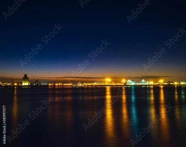 Fototapeta Liverpool, UK. Beautiful colorful long exposure shot of river Mersey from Albert Dock with smooth reflections of night lights from the other side of a shore. 