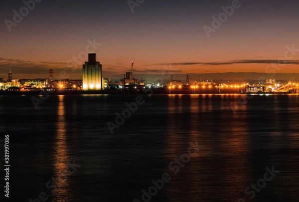 Fototapeta Liverpool, UK. Beautiful colorful long exposure shot of river Mersey from Albert Dock with smooth reflections of night lights from the other side of a shore. 