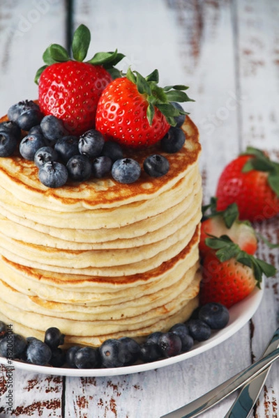 Fototapeta A stack if home-made pancakes with berry