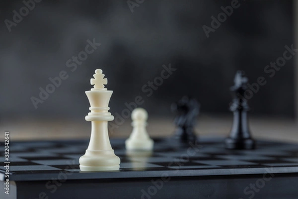 Fototapeta Business strategy concept with chessboard with figures on blurred background side view.