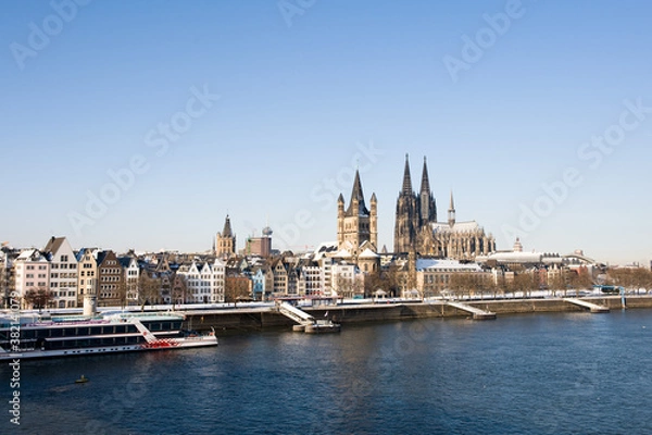 Fototapeta Panorama of the old center and Cathedral of Cologne in winter with snow on roofs