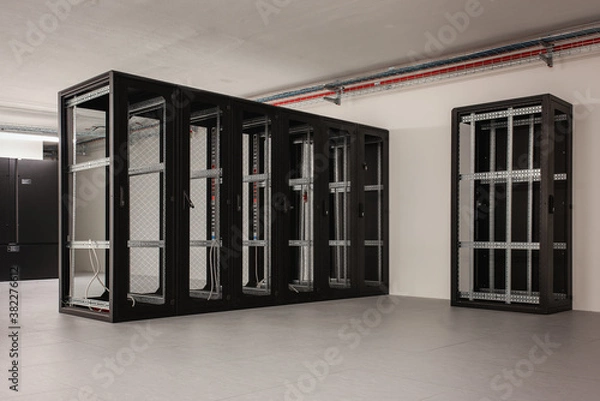 Fototapeta Server racks under construction in a data center hall.