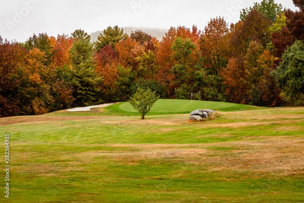 Obraz Granite rocks anchor the fairway on a golf course with fall leaf colors in bloom near Dedham, Maine