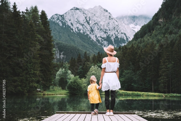 Fototapeta Mother and daughter together on nature. Family outdoor.