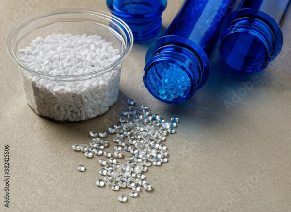 Obraz pet preforms and plastic granules on the surface