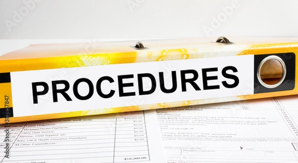 Fototapeta Text Procedures on the folder that is located on the financial reports