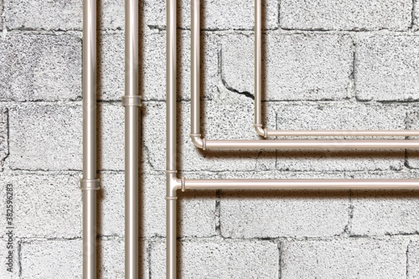 Fototapeta Water and gas metal pipeline in front of a concrete wall