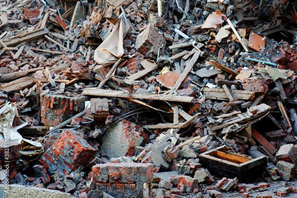 Fototapeta Pile of demolition rubble. Gray rubble at a building site. Concrete rubble debris on construction site