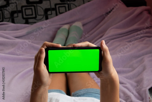 Fototapeta Phone with green screen, horizontal. Without fingers on the screen. Location - Limbazi, Limbazu novads, Latvia. Shoot date - 10/04/2020.