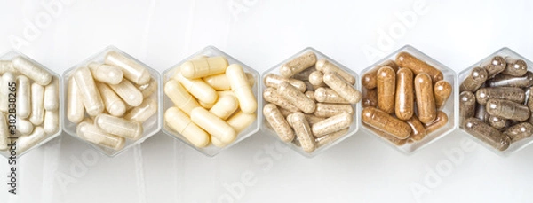 Fototapeta Various herbal and homeopathic medical capsules in hexagonal jars