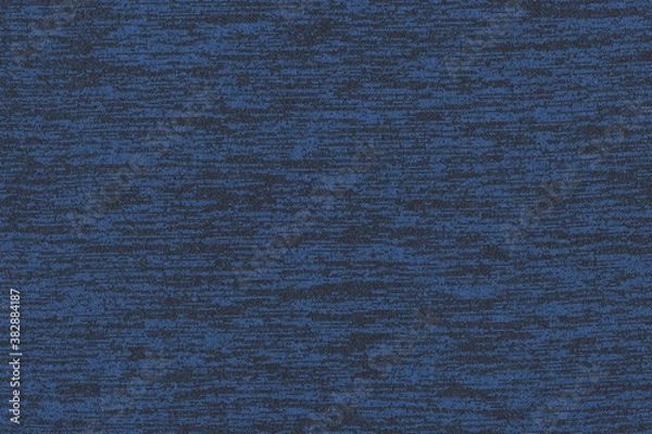 Fototapeta The texture of the knitted fabric is blue with black speckles. Soft fabric, casual clothing. Abstract monochrome background.