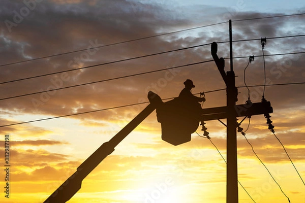 Obraz silhouette electrician works on cable car to maintain high voltage transmission lines.