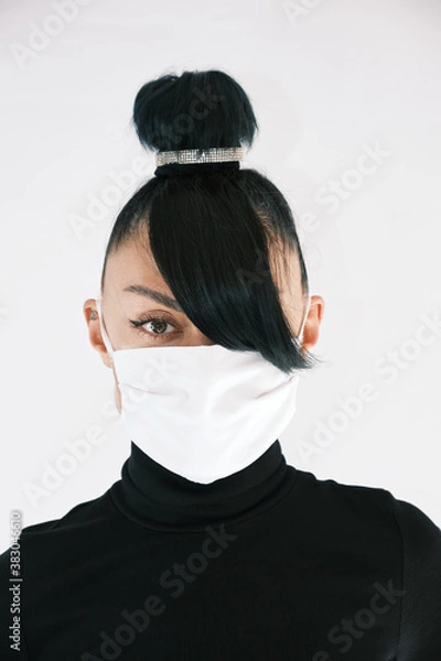 Fototapeta Girl in a white medical mask on a white background