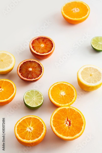Fototapeta Lime, lemon and orange slices on white background
