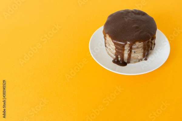 Obraz Chocolate cake with streams on a plate. Halloween celebration concept, trick or treat. Handmade cooking, brownies with flows down. Orange background, copy space. Selective focus, blur.
