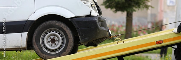 Obraz Wrecked car drives into tow truck. Service evacuation concep