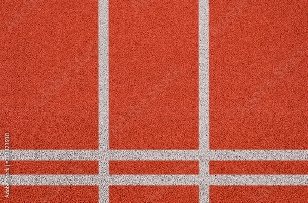 Obraz Top view of the running track rubber lanes cover texture with white line marking for background.