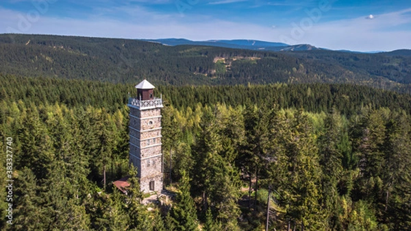 Fototapeta Pajndl, Czech republic - aerial view of old stone observation tower in Ore mountains, CZ: Krusne hory. Panoramic drone view of mountain range, forest and beautiful historical building in nature.