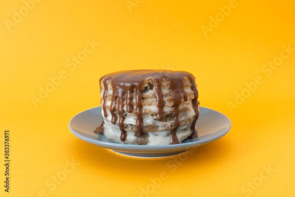 Obraz Chocolate cake with streams on a plate. Halloween concept, trick or treat. Cooking, sweets with flows down. Brownies with cream. Orange background, copy space. Selective focus, blur.