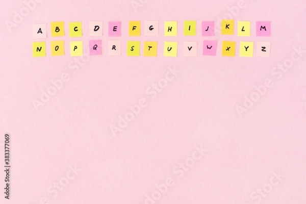 Obraz English alphabet completely. Two rows multicolored papers with abc letters on a pink background. Studying of foreign language. School lessons. Copy space, place for text.