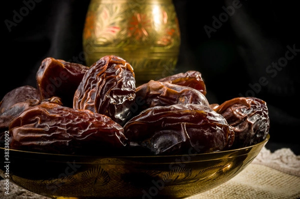 Fototapeta Big luxury dried date fruit in bowls on a linen napkin, kurma ramadan kareem concept, close up.