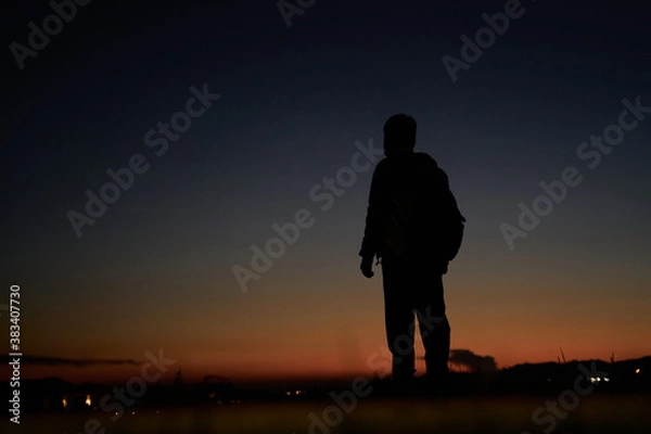 Fototapeta silhouette of a person on a sunset