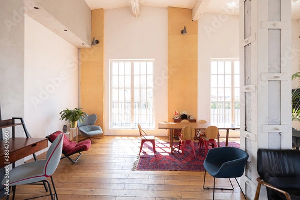 Fototapeta modern design of a huge white bright room with two red sofas and many large windows. full of sunshine. high ceiling and wooden parquet