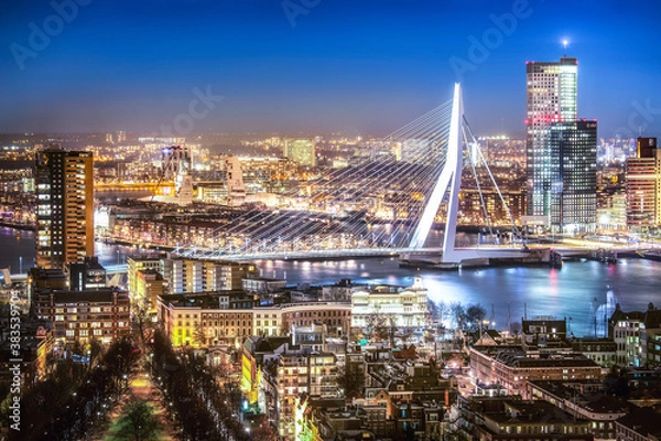 Fototapeta Rotterdam skyline with the Erasmus bridge at night seen from the Euromast tower, Netherlands.