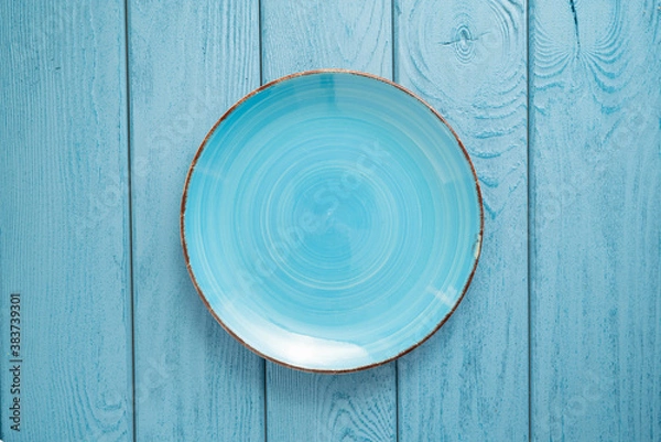 Fototapeta TOP VIEW: Empty blue bowl on blue wooden table